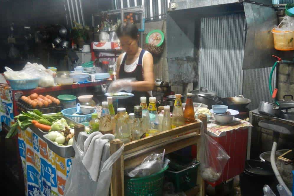Woman cooking thai food in her garage